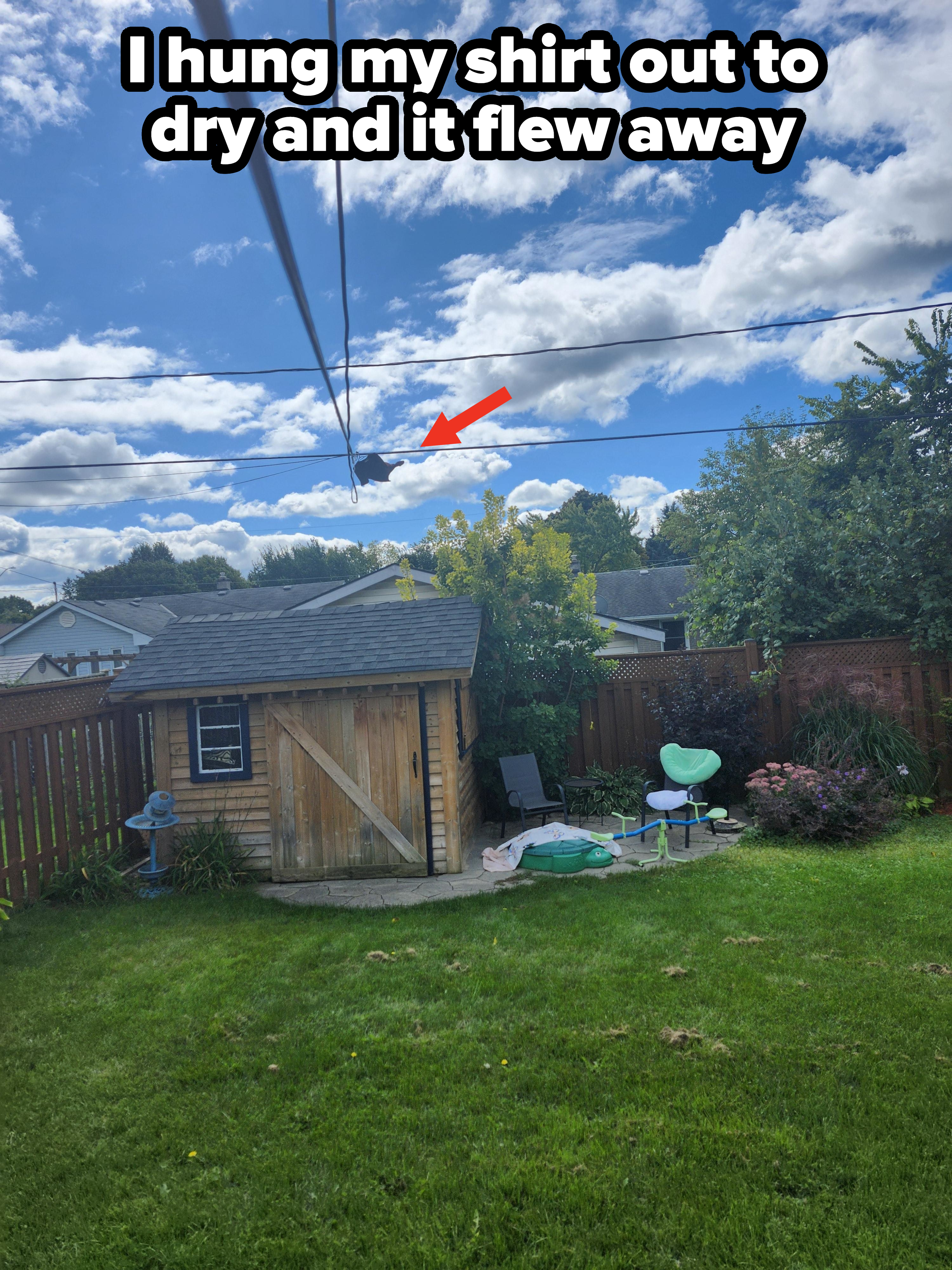 A backyard scene with a wooden shed, kids&#x27; swimming pool, slide, and various outdoor items. The sky is cloudy. No people are present