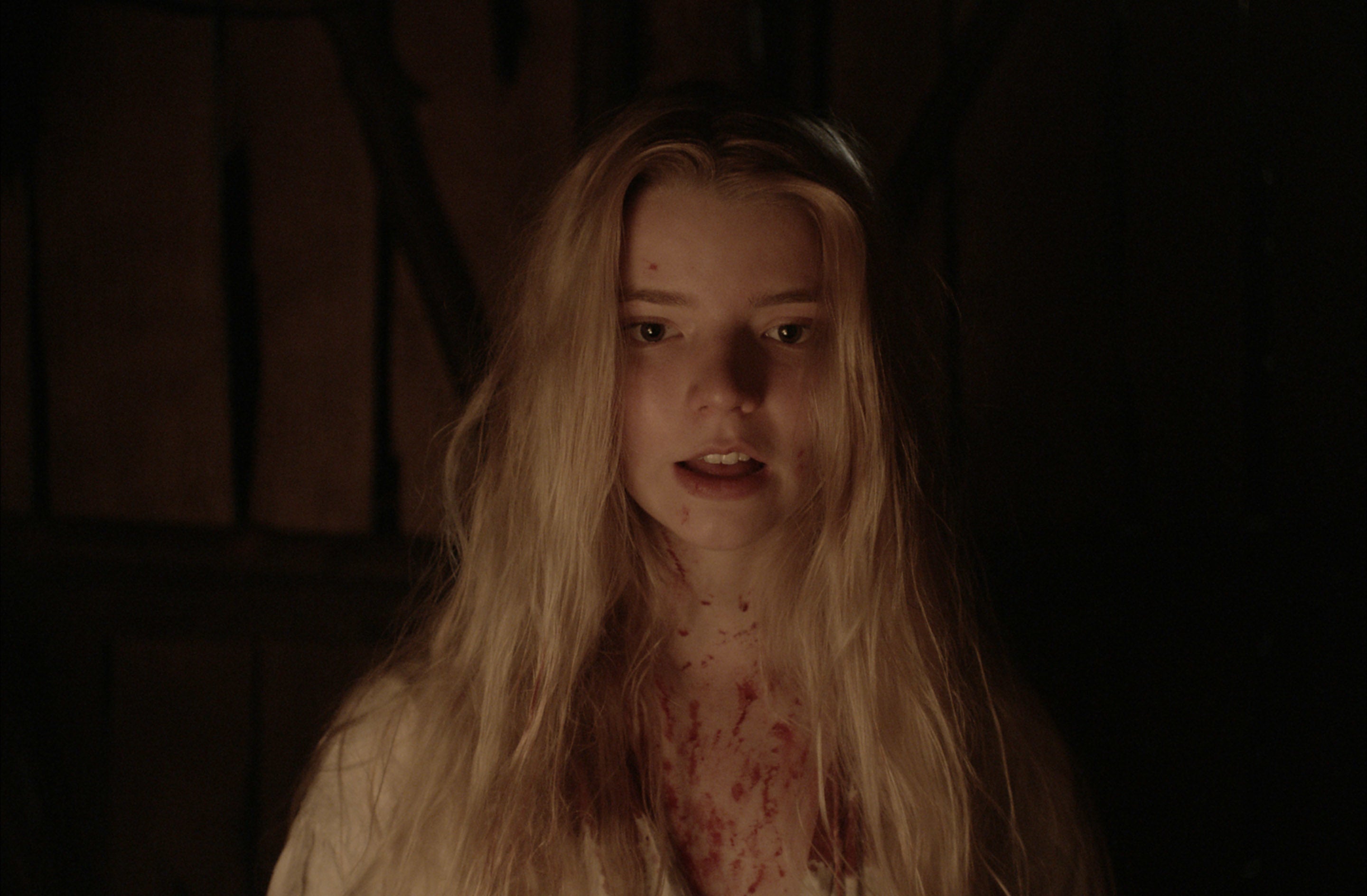 Anya Taylor-Joy with blood splatters on her chest in &quot;The Witch&quot;