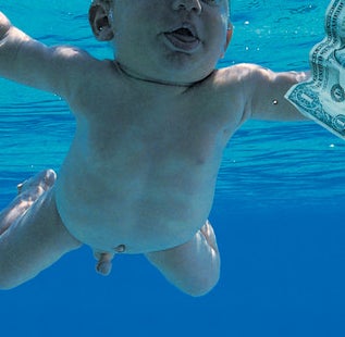 An infant underwater reaching for a dollar bill on a fishhook