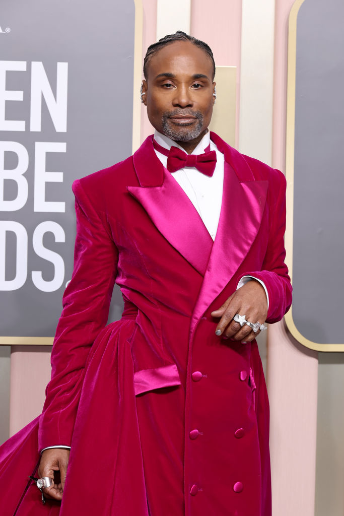 Billy Porter on the red carpet wearing a stylish velvet suit with a bow tie