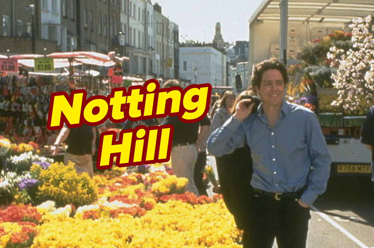 Hugh Grant on a street filled with flowers, with the words "Notting Hill" in large yellow text