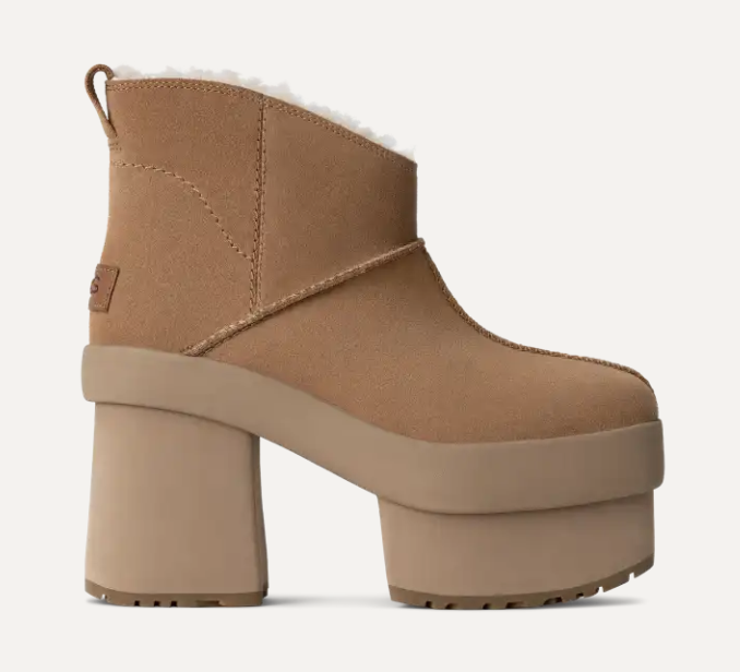 A tan, platform-heeled boot with a shearling lining, featuring a chunky, grooved sole and a short ankle design