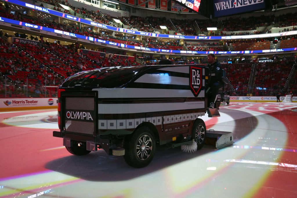 A Zamboni ice resurfacer smooths the rink during a break in a hockey game