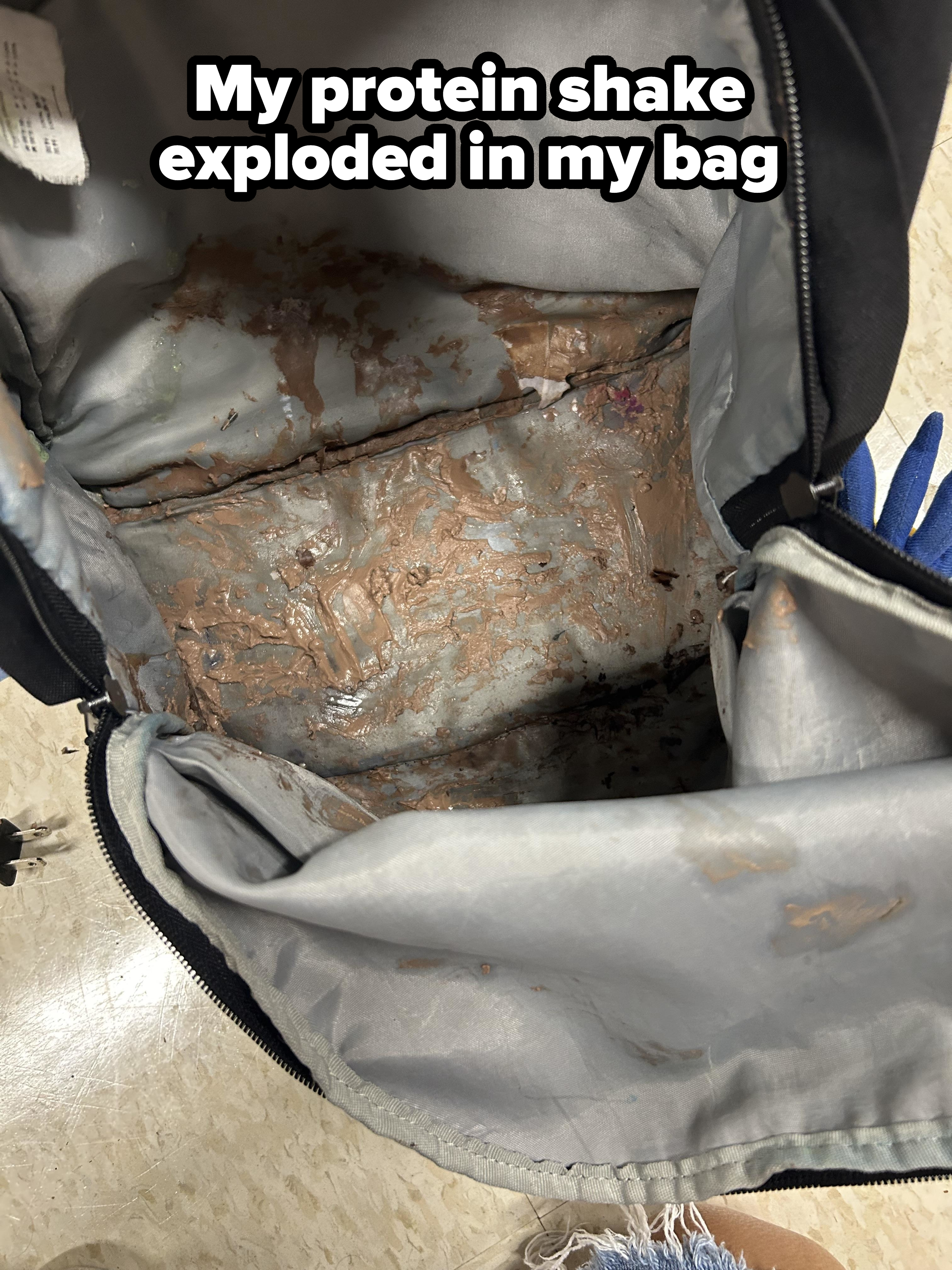 Open backpack with melted chocolate spilled inside, covering the interior fabric and items