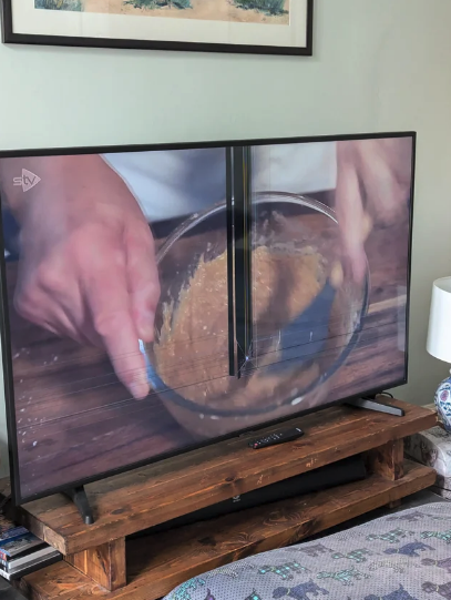 TV showing a close-up of hands mixing ingredients in a clear bowl