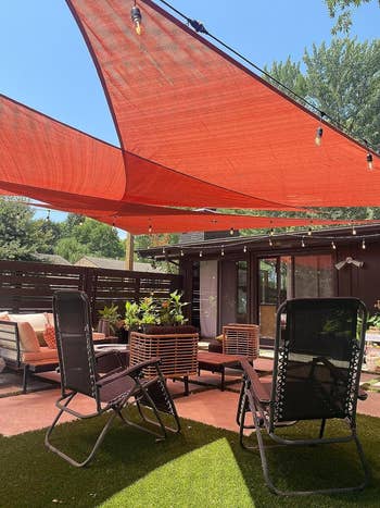 terra colored sail canopies above a backyard area