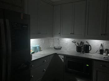 Kitchen with cabinets, countertop items, and under-cabinet lighting