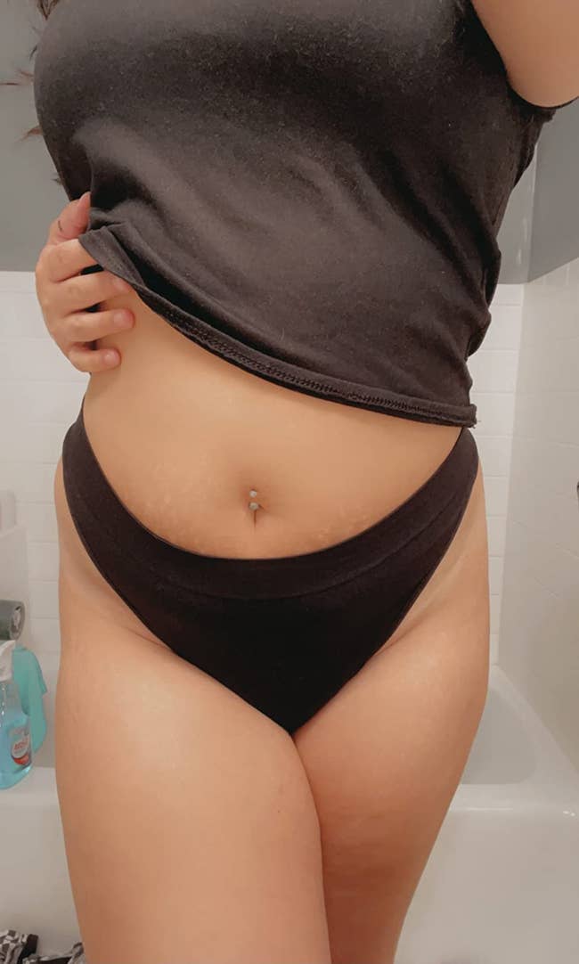 reviewer bathroom selfie wearing high-cut black thong