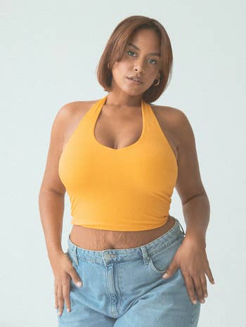 A model poses in a yellow halter-top