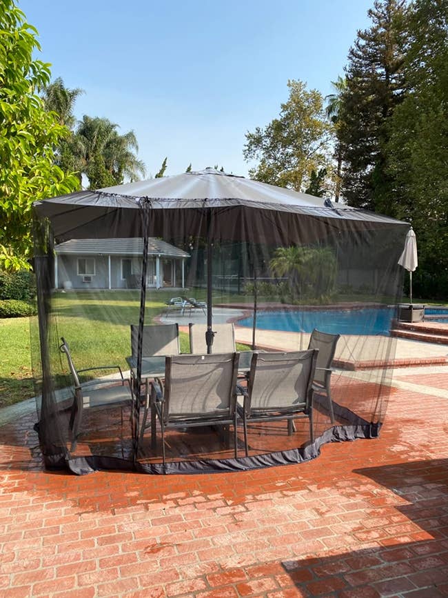 reviewer image of the netting over a patio furniture set outdoors