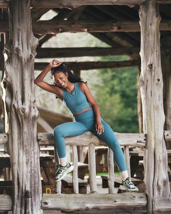 model in matching green leggings and tank