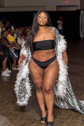 Reviewer wearing black seamless thong on runway