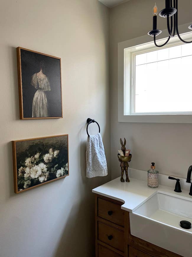 two paintings hanging in a reviewer's bathroom