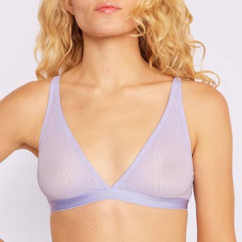 Model wearing purple plunge mesh bralette