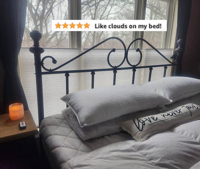 another reviewer's bed setup with pillows on them and 5-star review that reads 