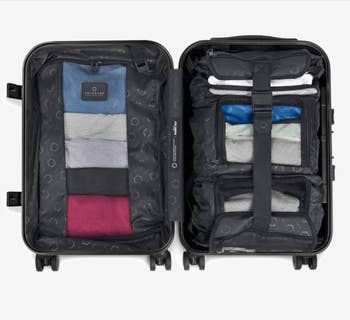 the open suitcase, which has several small storage compartments on one side and a larger one on the other