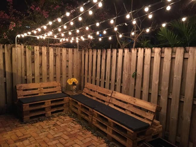 reviewer image of the string lights hanging on a back patio