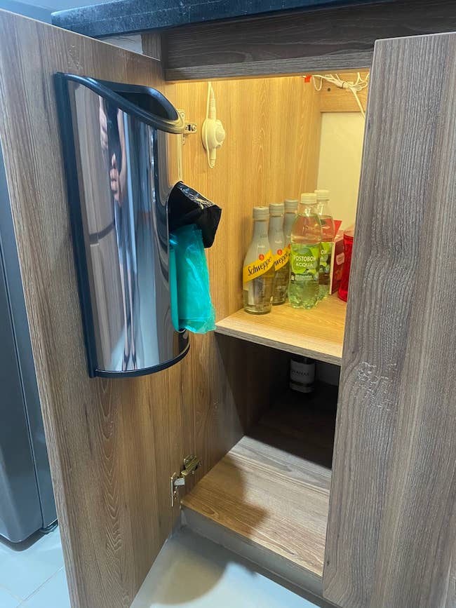 reviewer photo of the bag dispenser inside of cabinet