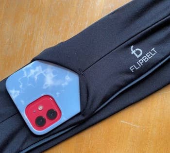 A phone sliding into the flipbelt 