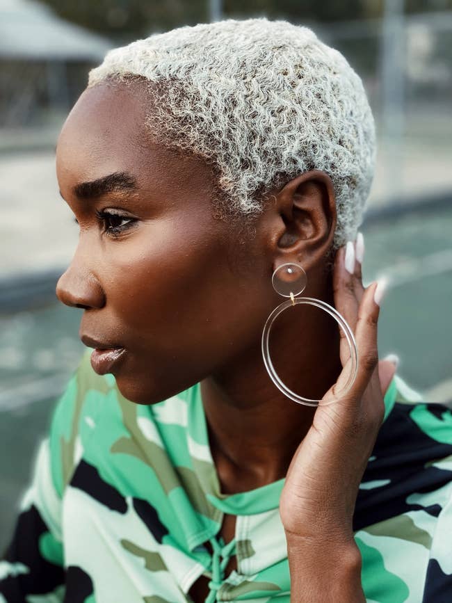 model wearing clear drop hoop earring