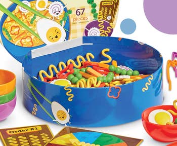 Toy play food set with colorful noodles, vegetables, utensils, and order cards. Set includes 67 pieces, encouraging imaginative play and creativity in children
