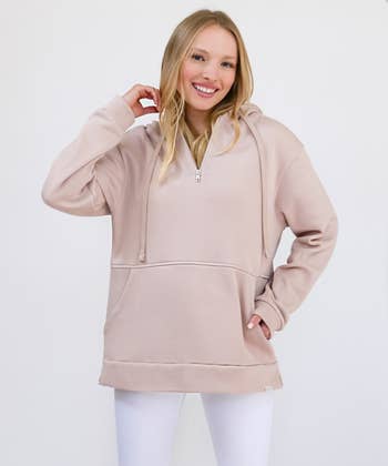 model wearing the dusty rose, oversized hoodie