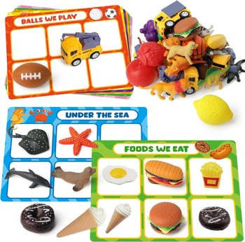 Children's educational toys on a tabletop, including sorting cards with themes like 