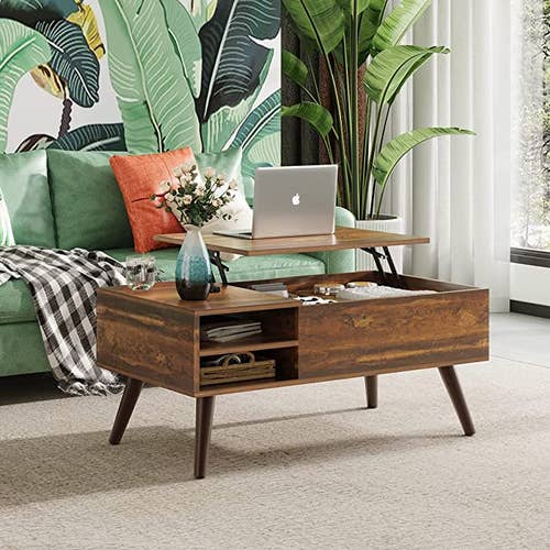 photo of the coffee table with laptop on the lifted top