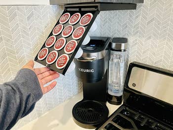 reviewer photo revealing the enclosed coffee pod tray