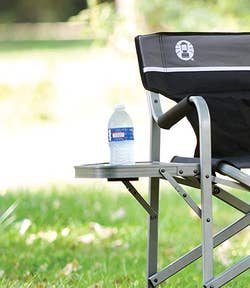 a water bottle in the side table of the camper chair