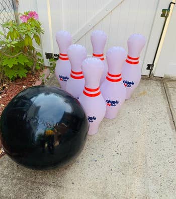 reviewer's giant inflatable bowling ball and pins in yard