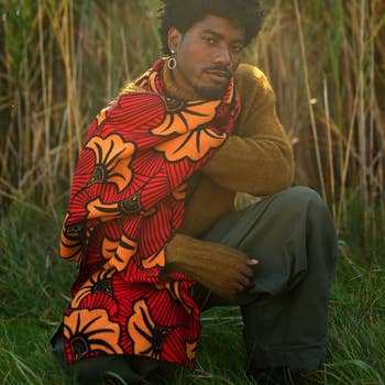 model in red and orange oversize scarf