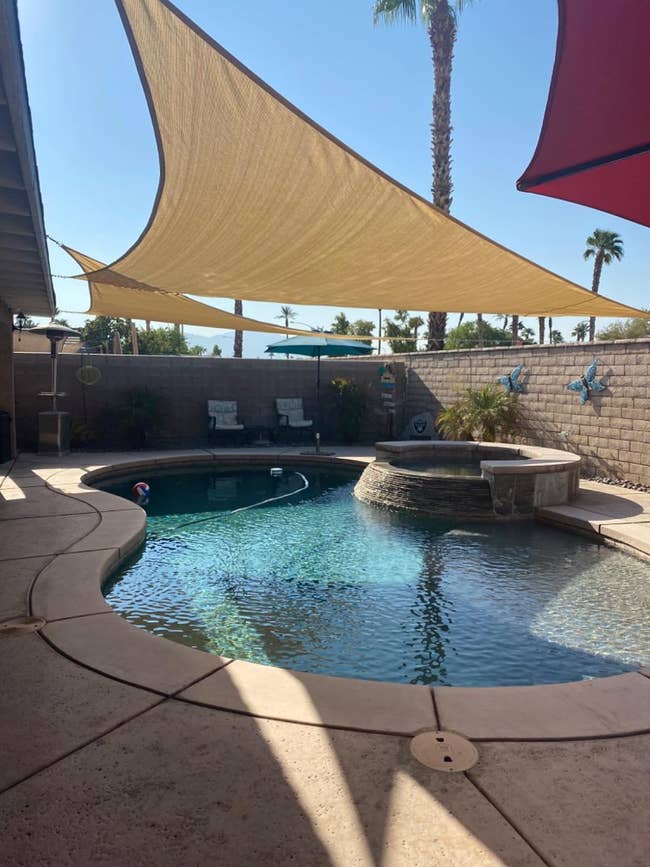 Two sun shades over a pool