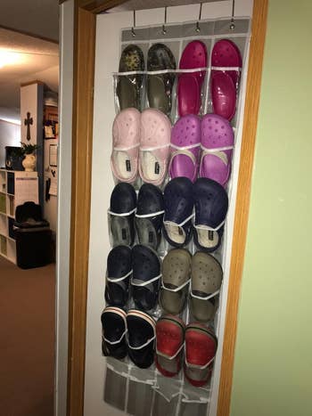another reviewer's gray hanging organizer on a door storing many pairs of shoes