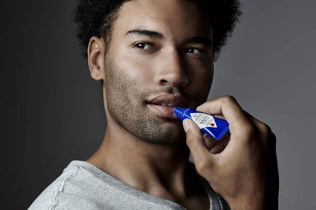 model applying the lip balm