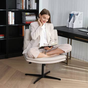 A model sitting in the chair with their legs crossed