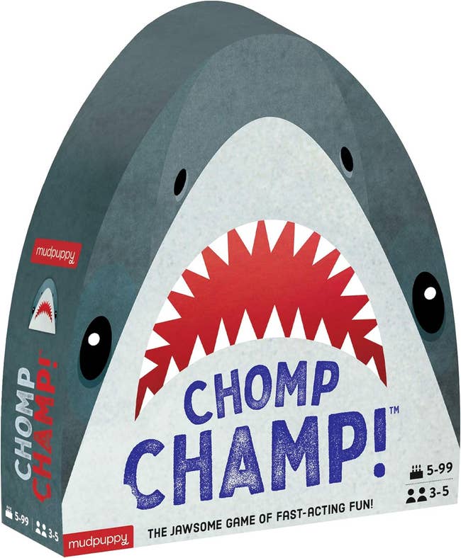 Front packaging of the game 'Chomp Champ!' by Mudpuppy, featuring a shark design and details about player age range (5-99) and number of players (3-5)