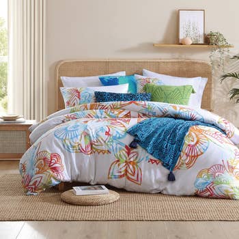 Bedroom with a bed adorned with a patterned comforter set and decorative pillows