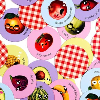 Circular stickers featuring various fruits and vegetables with quirky facial expressions and text such as sleepy pomegranate, jolly tomato, and hurt fig