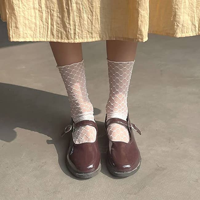 model wearing white mesh socks with mary janes