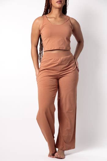 model wearing a sleeveless top with matching pants in skin tone colorway