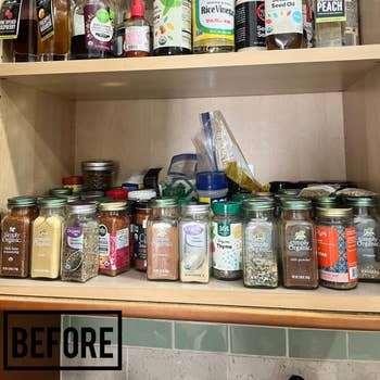Shelf with organized jars of spices and assorted bottles of oils and vinegar