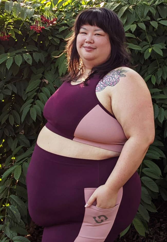 model in colorblock light pink and burgundy sports bra