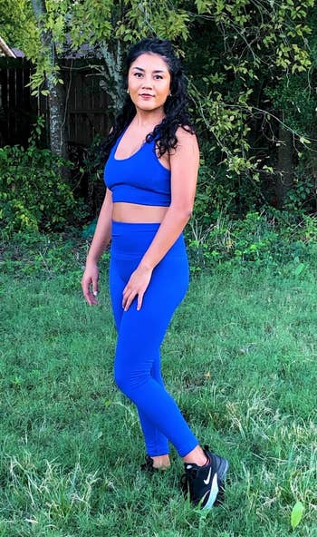 reviewer in deep blue matching sports bra and leggings set