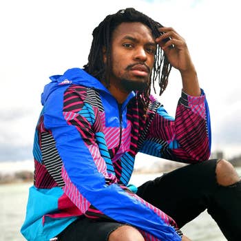 person in a vibrant patterned jacket posing outdoors