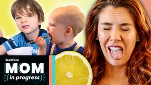 Hannah making a face from a sour lemon and her kids eating food behind her.