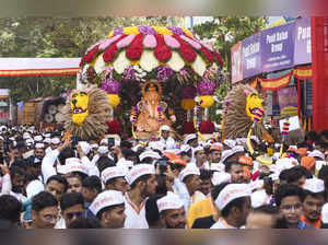 Pune: Devotees carry an idol Lord Ganesh to a 'puja pandal' during the Ganesh Ch...