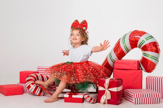 Bambina di vista frontale circondata da elementi di Natale