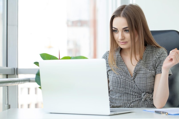 Donna d'affari Donna d'affari impegnata a lavorare su un computer portatile in ufficio