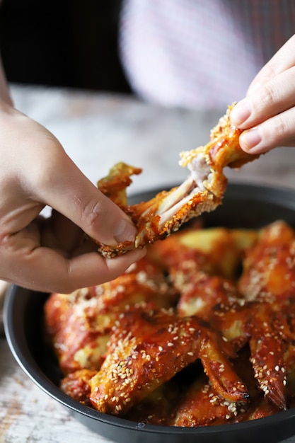 L'uomo mangia ali di pollo. Ali di pollo fritto